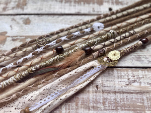 blonde dreadlocks with gold, brown and cream decorations