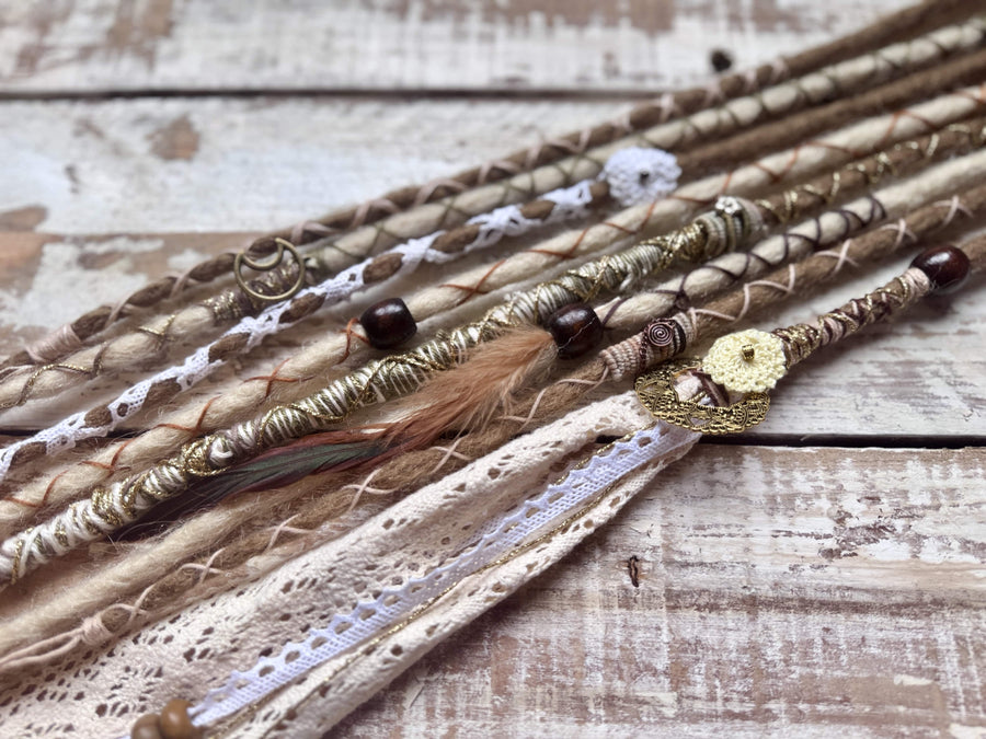 blonde dreadlocks with gold, brown and cream decorations