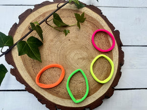 neon pink, yellow, orange and green hair ties