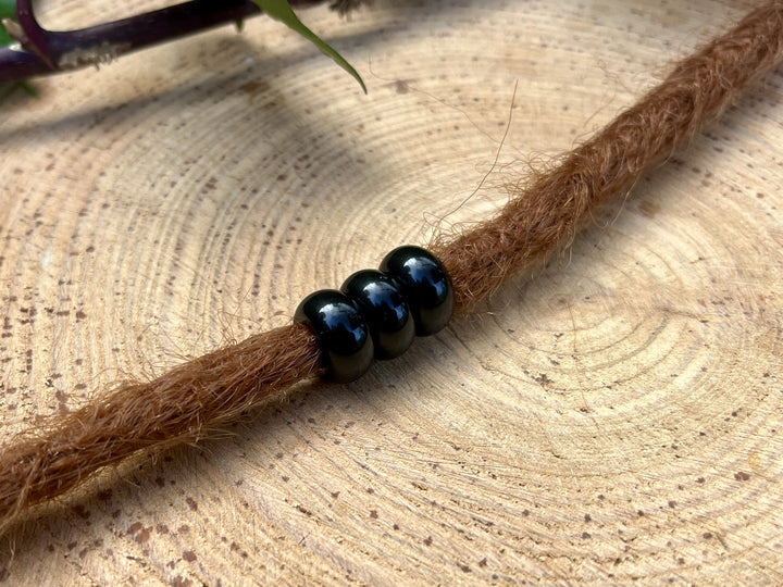 Obsidian dreadlock beads on dreadlock