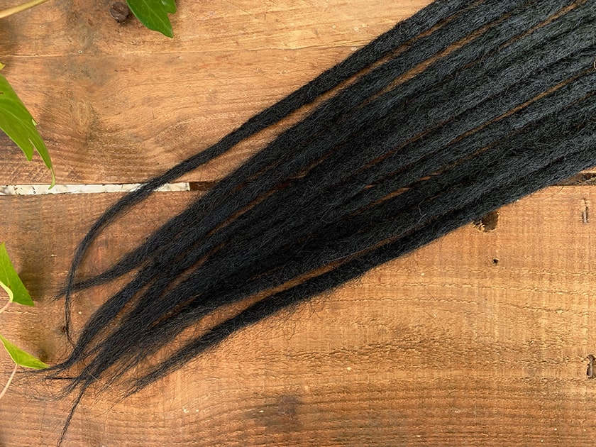 Black synthetic dreadlock extensions with whispy ends