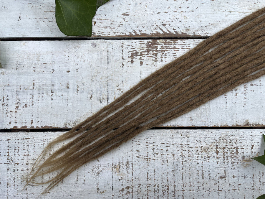 pencil thin honey blonde dreadlock whispy ends